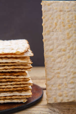 Matza sheets on a round stand on a wooden table. copy space.の写真素材
