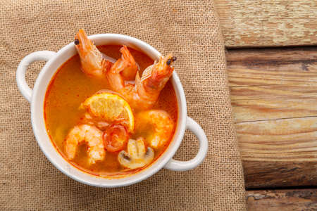 Tom yam soup with shrimps and coconut milk in a tureen.の写真素材
