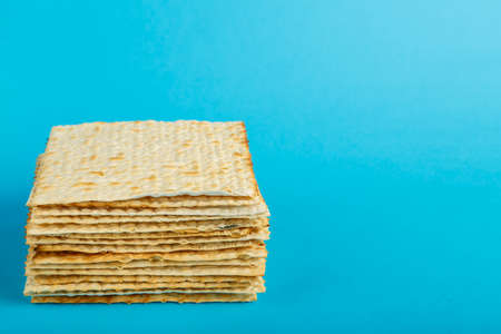 Matzo plates laid on top of each other on a blue background.の写真素材