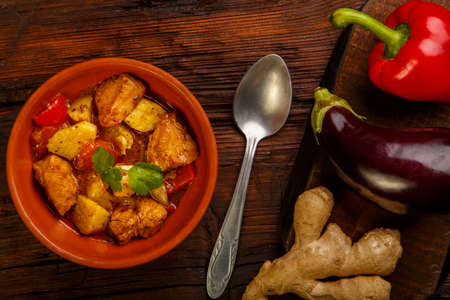 Food for suhoor in ramadan lamb stew with potatoes vegetables and a spoon on a wooden background. Horizontal photoの写真素材