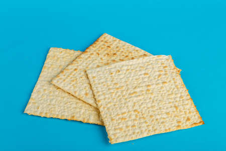 Matzo plates laid out in any shape on a blue background. Horizontal photoの写真素材