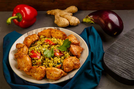 Food for suhoor in Ramadan bulgur fast with beef in a plate on a blue napkin next to vegetables. Horizontal photoの写真素材