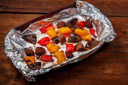 Antipasta baked on foil in the form on a wooden table. horizontal photoの写真素材