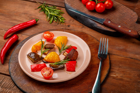 Antipasta on a plate on a wooden table next to vegetables on wooden boards. horizontal photoの写真素材