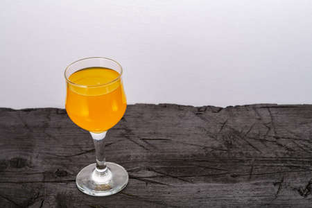 Orange juice in a glass on a black background. Horizontal photoの写真素材