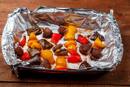 Antipasto baked in foil on a wooden table. Horizontal photoの写真素材
