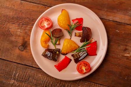 Vegetable antipaste on a plate on a wooden table. Horizontal photoの写真素材