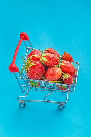 Fresh large strawberries in a grocery cart. Vertical photoの写真素材