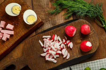 Vegetables and a knife on wooden planks on the table.の写真素材