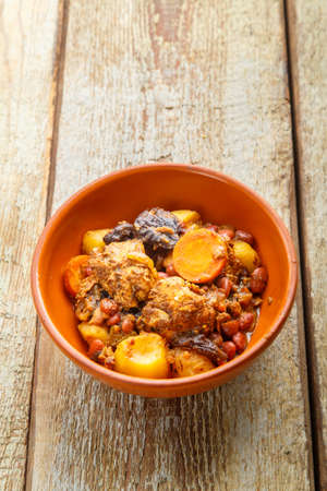 Jewish dish chelnt with meat on a wooden table in a plate. Vertical photoの写真素材