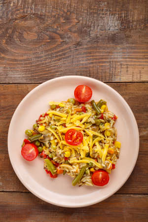 Risotto with mushrooms in a beige plate on a wooden background.の写真素材