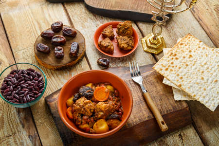 Jewish dish with meat on a stand next to matzo, fork and ingredients. Horizontal photoの写真素材