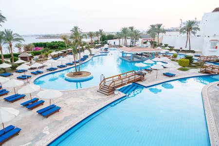 Swimming pool with sun loungers on site next to the sea. Horizontal photoの写真素材
