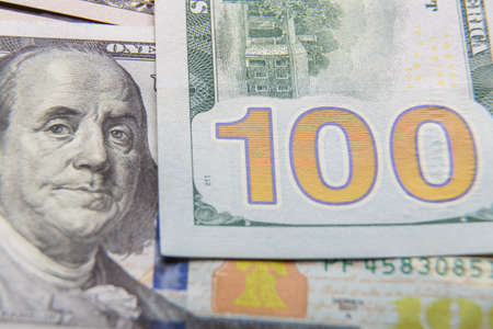 Fragments of dollar bills with a protective strip on a flat surface, very close-up.
