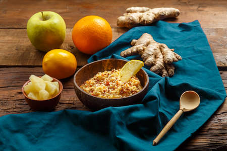 Couscous masfouf with dried fruits and nuts in a plate on a blue napkin next to fresh fruits. horizontal photoの写真素材