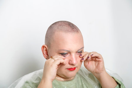 A Jewish Hasidic woman from the Orthodox community cries her bald head after her wedding. horizontal photoの写真素材