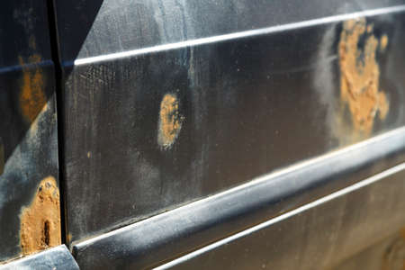 Rusted from old age car door in need of repair. horizontal photo