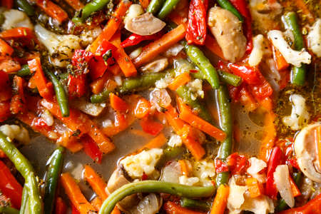 Bright colored vegetables in a frying pan stewed in spices. horizontal photoの写真素材