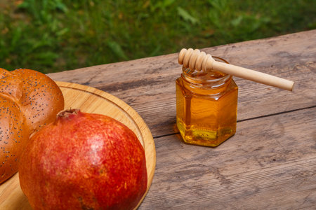 Challah pomegranate and honey on wooden boards for Rosh Hashanah. horizontal photoの写真素材