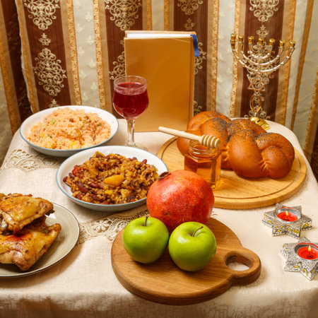 Festive table with ritual traditional dishes and menorah and siddur for Rosh Hashanah. square photoの写真素材
