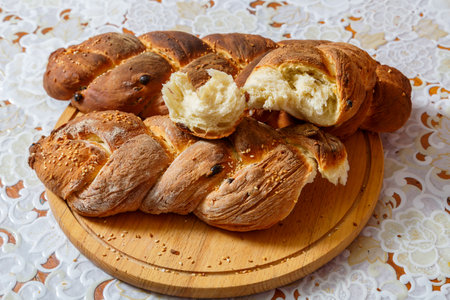 Sour challahs on a wooden round board on a white tablecloth. horizontal photoの写真素材