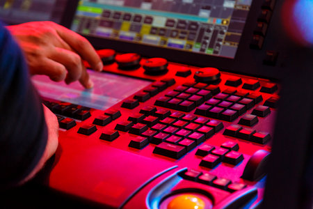 Stage light control panel professional lighting engineer hands work on it. horizontal photoの写真素材