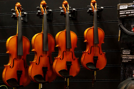 Illustrative editorial Various models of a violin hanging in a store for sale. horizontal photoの写真素材
