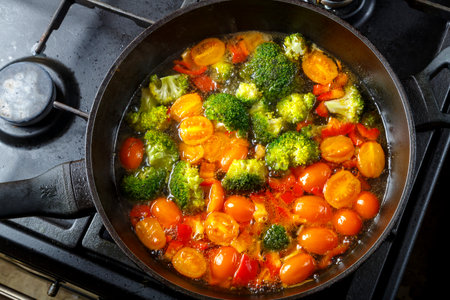 Stewed vegetables beans broccoli tomatoes stewed with spices in a frying pan. horizontal photoの写真素材