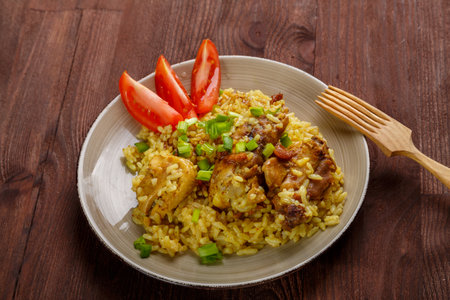 Thai chicken rice on a wooden table next to a wooden fork. horizontal photoの写真素材