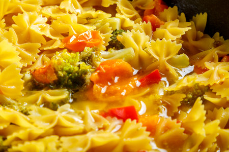 Farfalle pasta with stewed fresh vegetables and spices.close-up. horizontal photoの写真素材