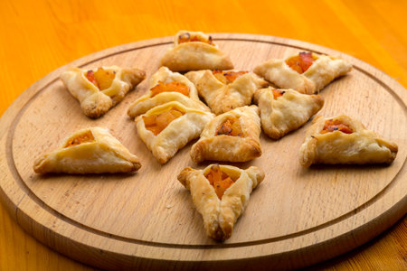 Sweet gomentashi cookies for the Purim holiday on a chalkboard are laid out on a blackboard on a light table. horizontal photo.の写真素材