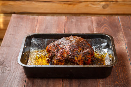Whole chicken baked in sauce and spices brown crust on a baking sheet. horizontal photoの写真素材