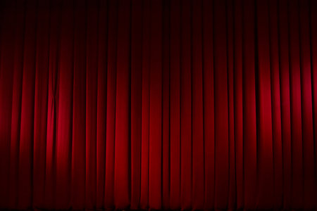 Theatrical stage curtain red in the light of spotlights. horizontal photo.の写真素材