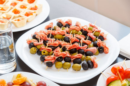 caviar and canape with olives and cheese ham on white buffet tables. horizontal photoの写真素材