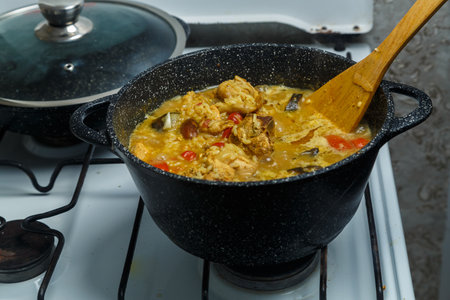 Braised eggplant with meat and Israeli rice in a cast-iron high frying pan on the stove. horizontal photoの写真素材