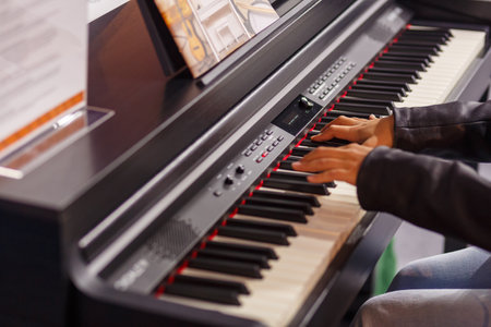A musician's hands test a piano at an exhibition of musical instruments. horizontal photo