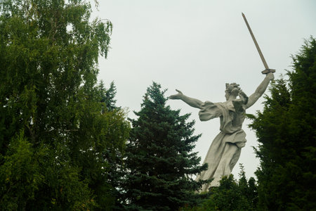 July 25, 2023, Russia, Volgograd, Mamaev Kurgan, motherland view from behind the trees.のeditorial素材