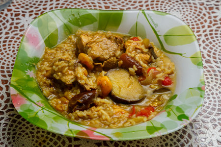 Braised eggplant with meat and rice with dogwood in Israeli style in a plate on the table. horizontal photoの写真素材