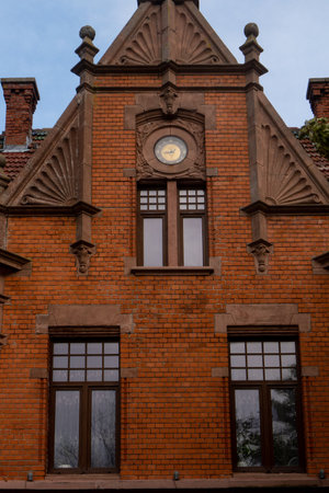 October 7, 2023 Russia, Zelenogradsk, private houses of German construction made of red brick with pointed roofs and forged spiers. Vertical photo.のeditorial素材