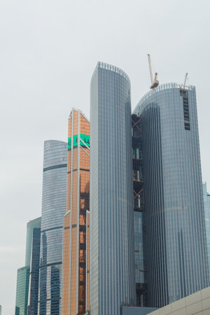 September 21, 2023 Russia Moscow high-rise international exhibition business center Moscow City against the background of a cloudy sky. Vertical photo.のeditorial素材