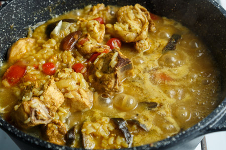 Braised eggplants with meat and rice in Israeli spices in a cast-iron high frying pan close-up.の写真素材