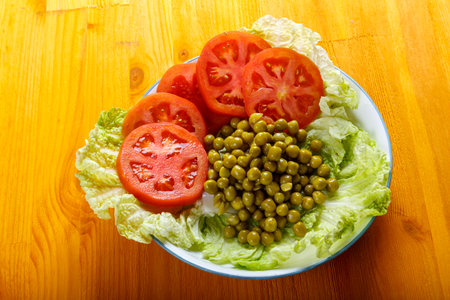 Vegetables in a plate appetizer cucumber, tomato, peas, Chinese cabbage. horizontal photoの写真素材