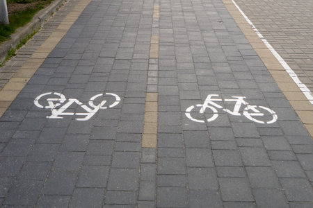 Two-lane bicycle path with painted signs and paved road tiles. horizontal photoの写真素材