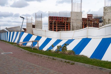 Fenced area construction site building under construction. horizontal photo