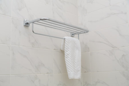 Metal towel holder against a white wall in the bathroom. Horizontal photo.の写真素材
