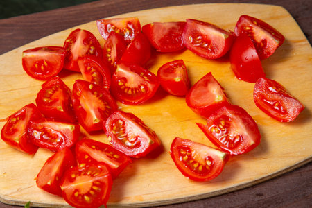Cherry tomato cut in half on a wooden board. horizontal photoの写真素材
