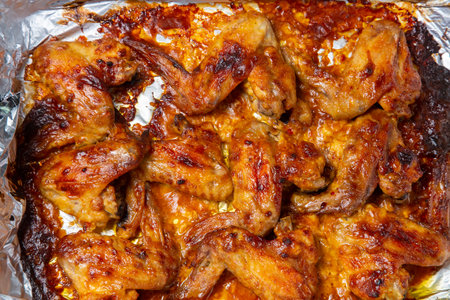 Chicken wings baked in soy sauce and garlic marinade with a crispy crust close-up. Horizontal photo.の写真素材