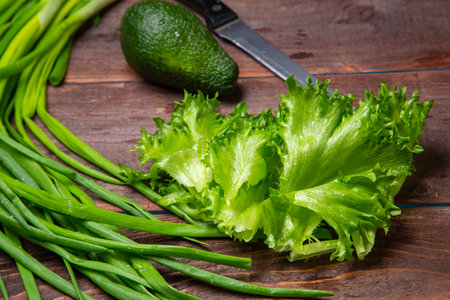 Avocado lettuce leaves and green onions on the table. Horizontal photo.の写真素材