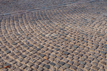 Square pavement paved with gray cobblestones rectangles texture. horizontal photo