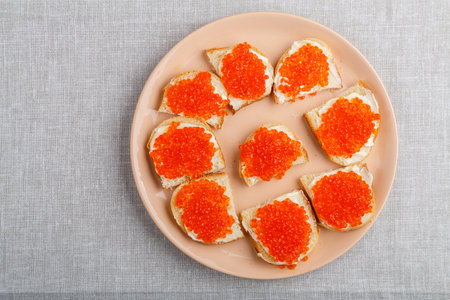 Sandwiches with red caviar on the table on a white tablecloth. horizontal photoの写真素材